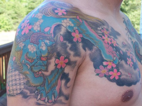 Asian Foo Dog Tattoo On Chest And Shoulder
